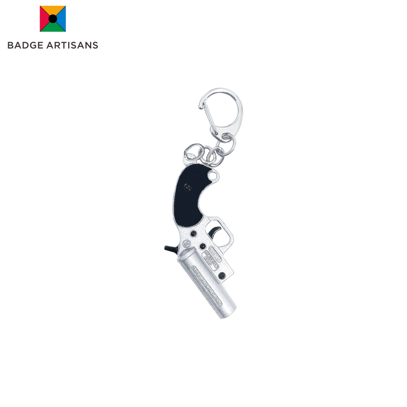 Gun-shaped metal keychain custom designed with black and silver finish – ideal for promotional or retail use
