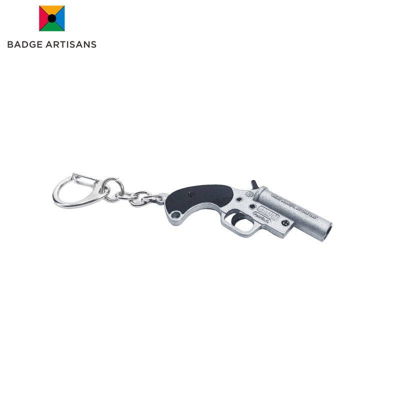 Close-up of custom firearm keychain made of zinc alloy with matte metal texture