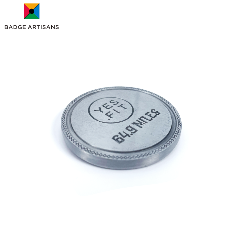 Close‑up of coin’s matte brushed silver‑alloy surface highlighting fine‑detail relief and scratch‑resistant texture