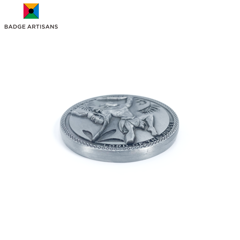 Close‑up of coin’s matte brushed silver‑alloy surface highlighting fine‑detail relief and scratch‑resistant texture